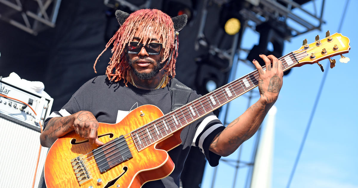 Artist Thundercat Playing a Guitar